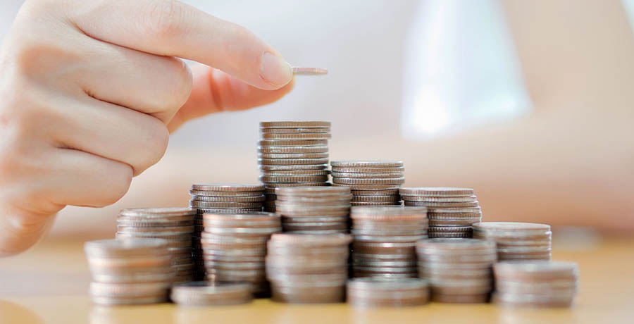 Hand put coins to stack of coins on white background Hand put coins to stack of coins on white background