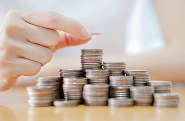Hand put coins to stack of coins on white background